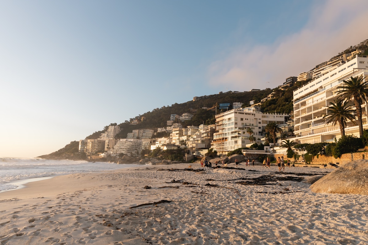Clifton beach at golden hour with apartment buildings on the hillside above, Cape Town, South Africa