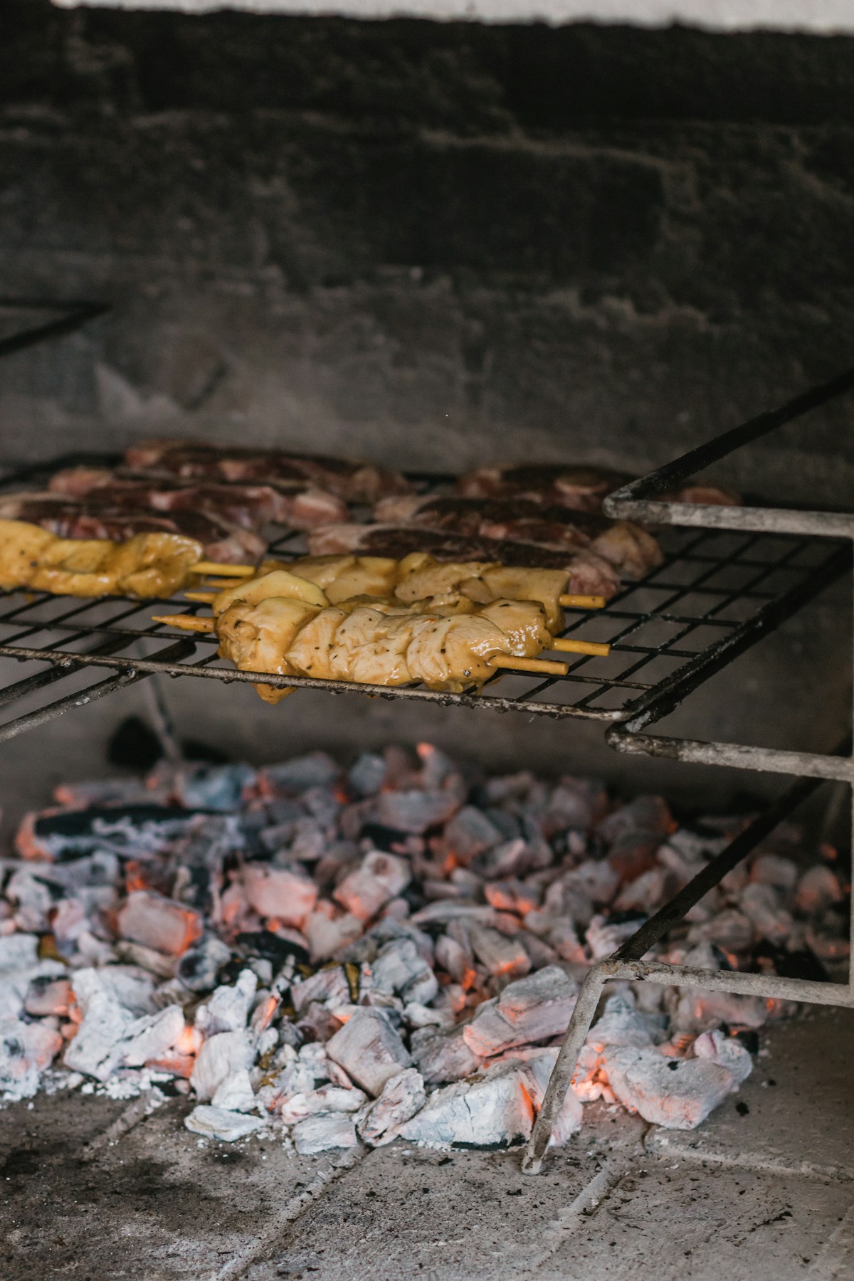 Meats cooking on a traditional braai grill — South Africa food culture