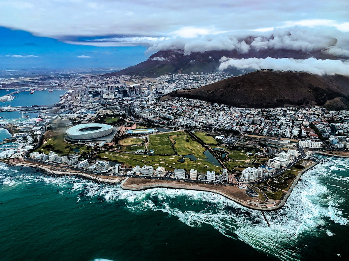 Aerial view of Cape Town with DHL Stadium, the Atlantic Ocean, and Table Mountain rising behind the city, South Africa
