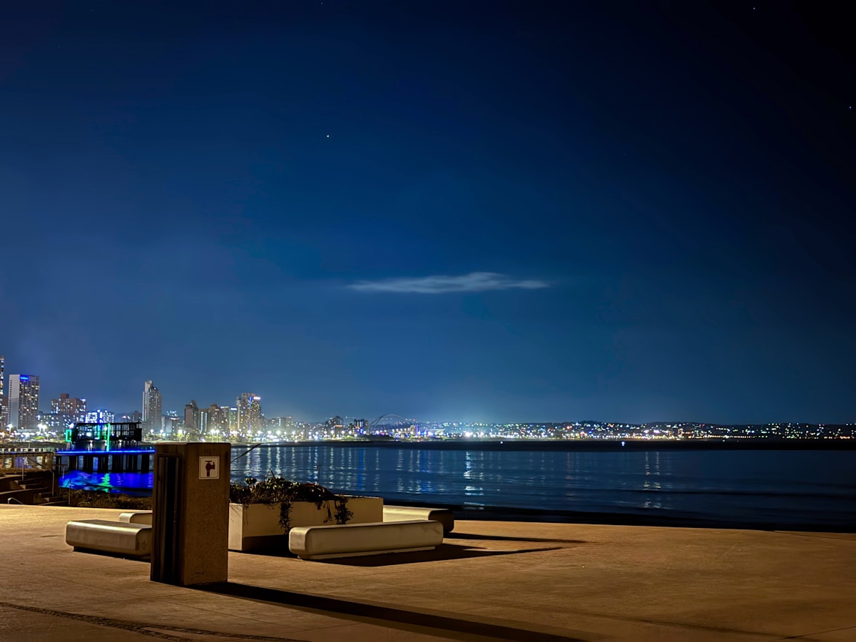 Durban city skyline illuminated at night across the water, KwaZulu-Natal, South Africa