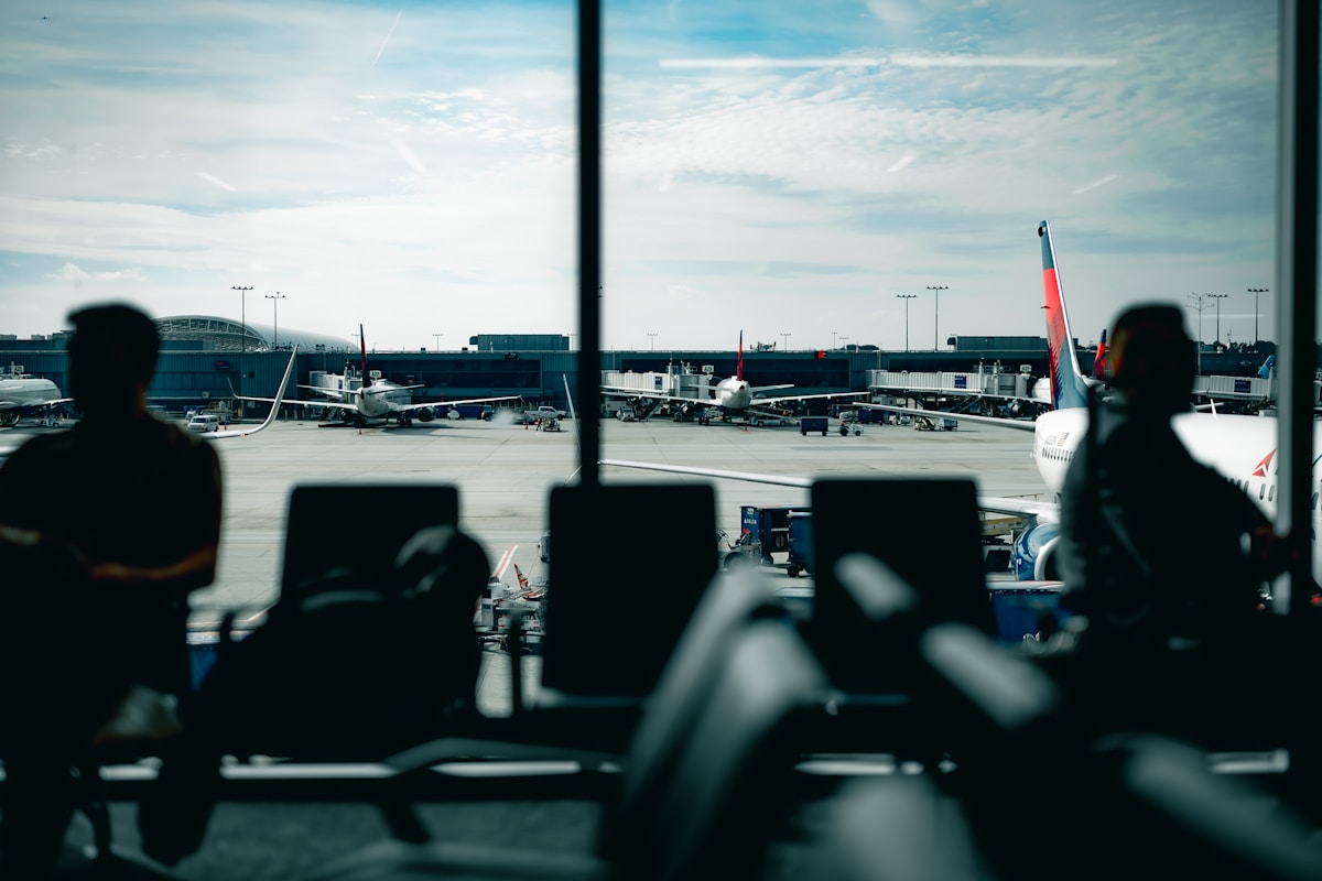 Passengers waiting at an airport gate — flight delay compensation guide