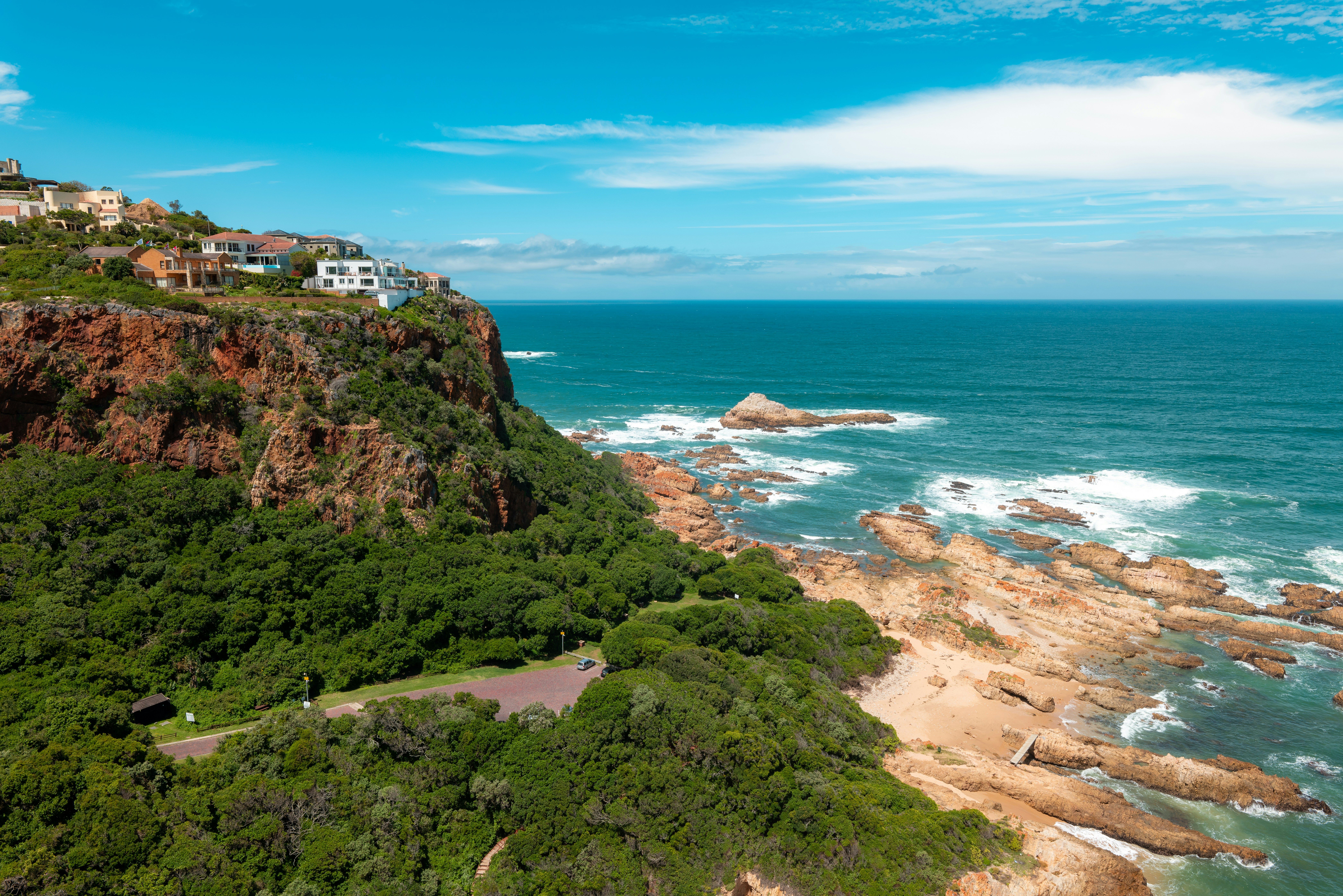 Dramatic cliffs and turquoise sea at Knysna Heads, Garden Route, South Africa