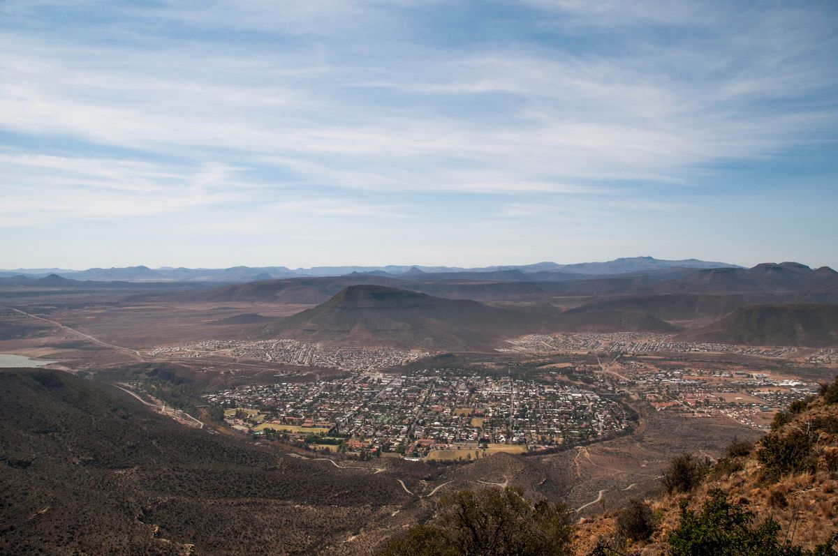 Aerial view of Graaff-Reinet town nestled in a Karoo basin surrounded by dramatic mountains, Eastern Cape, South Africa