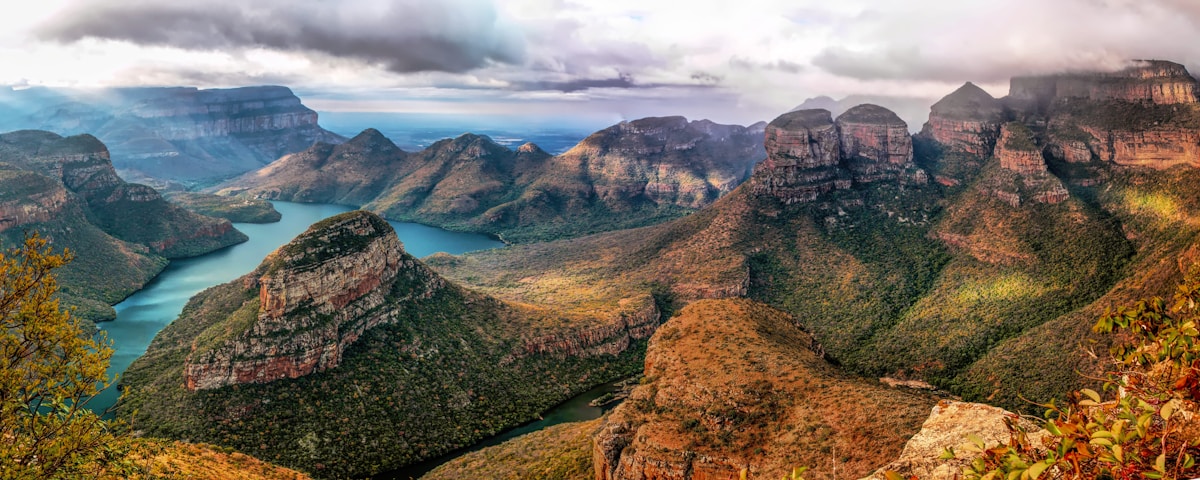 A composite of South Africa highlights — Table Mountain, a Kruger elephant, and a Garden Route coastline