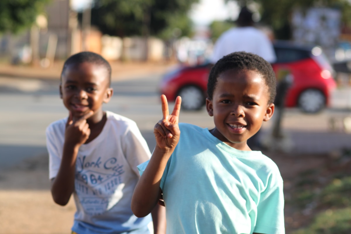 Two young boys playing on a Soweto township street, Johannesburg, South Africa